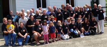 Group of church members posing in front of the church.